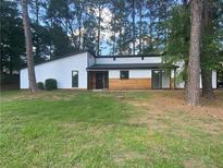 Modern exterior with white siding and wood accents at 51 Holt Ne Rd, Marietta, GA 30068