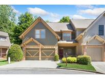 Two-story townhome with gray siding, two-car garage, and landscaping at 1400 Village Creek Se Cir # 12A, Atlanta, GA 30316