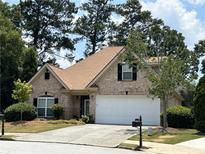 Brick home with a two-car garage and well-maintained landscaping at 252 Madison Park Dr, Grayson, GA 30017