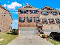 Brick townhouse with two-car garage at 2286 Foley Park St, Snellville, GA 30078