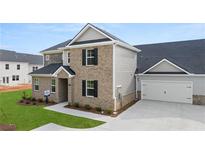 Two-story brick home with gray accents and attached garage at 580 Silver Moon Dr, Loganville, GA 30052