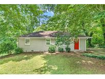 Cozy ranch home with gray brick exterior and red door at 1743 Hollyhock Ter, Decatur, GA 30032