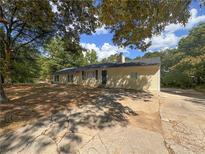House exterior featuring a yellow siding and a long driveway at 6862 Old Beulah Rd, Lithia Springs, GA 30122