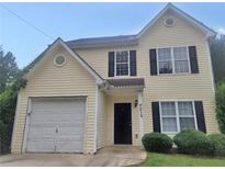 Charming two-story home with attached garage, front yard, and black shutters at 7015 Setters Way, Lithonia, GA 30038