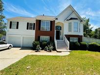 Two-story house with attached two-car garage and manicured lawn at 87 Creston Ct, Powder Springs, GA 30127