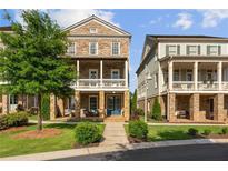 Front view of charming two-story townhouses with welcoming porches at 7445 Cordery Rd, Cumming, GA 30040