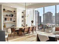 Modern dining room with large windows, hardwood floors, and a long wooden table at 40 12Th Ne St # 1005, Atlanta, GA 30309