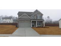 Two story house with gray siding, stone accents and a 2 car garage at 6093 Ruby Falls Way, Stonecrest, GA 30038
