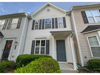 Townhouse exterior featuring a gray door and well-manicured landscaping at 6531 Arbor Gate Sw Dr # 12, Mableton, GA 30126
