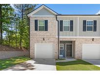 Front view of a two-story townhome at 7041 Livia Pt, Riverdale, GA 30296
