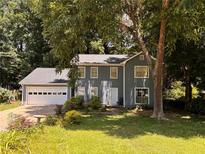 Two-story house with attached garage and mature trees at 5025 Cold Springs Nw Dr, Lilburn, GA 30047