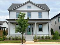 Two-story Craftsman home with a front porch and landscaping at 1356 Flora Dr, Conyers, GA 30094