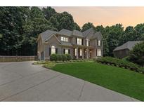 Two-story home with stone accents and landscaping at 6925 Keswick Ct, Cumming, GA 30040