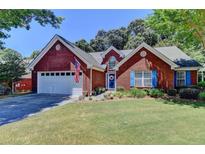 Brick ranch home with a white garage door and blue shutters at 3550 Rivers End Pl, Buford, GA 30519