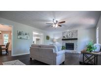 Living room boasts a cozy fireplace and hardwood floors at 285 Powder Creek Way, Dallas, GA 30157