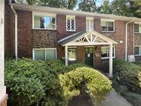 Brick building exterior with landscaping and a covered entrance at 2416 Peachwood Ne Cir # 9, Atlanta, GA 30345