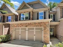 Two-story home with stone exterior, three-car garage, and landscaping at 4206 Weavers White Ln # 17, Austell, GA 30106