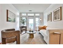 Bright living room with access to balcony, neutral colors, and modern furniture at 3334 Peachtree Ne Rd # 704, Atlanta, GA 30326