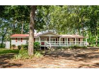 House exterior showcasing a front porch and tree-lined yard at 146 Mount Bethel Rd, Mcdonough, GA 30252