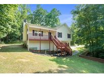 Two-story house with a wooden deck and stairs at 5918 Highway 20 Se, Cartersville, GA 30121