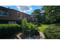 Inviting townhome with lush landscaping and a manicured lawn at 3010 Parc Lorraine, Lithonia, GA 30038