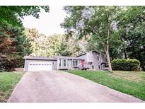 Gray house exterior with a white garage door and red front door at 377 Mill Ridge Way, Lawrenceville, GA 30046
