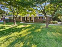 Brick ranch home with a spacious lawn and mature trees at 2656 Eldorado Pl, Snellville, GA 30078