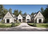 Luxury home exterior with stone accents and a three-car garage at 841 Woodvale Pt, Suwanee, GA 30024