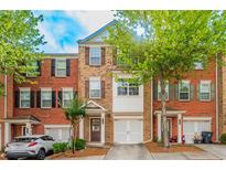 Brick townhouse with two-car garage and landscaping at 2100 Meadow Peak Rd, Duluth, GA 30097