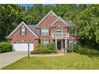 Two story brick home with a balcony and attached garage at 714 Beacon Cv, Lawrenceville, GA 30043