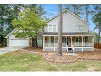 Two story house with stone accents and wrap around porch at 3340 Underwood Se Rd, Conyers, GA 30013