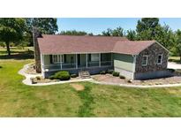 Ranch-style house with stone accents and a large yard at 3060 Habersham Cir, Covington, GA 30014