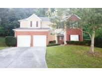 Two-story brick home with a double garage and neat lawn at 5179 Meadowbrooke Chase, Stone Mountain, GA 30088