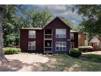 Exterior view of a two-story brown building with trees at 5555 Mountain Springs Cir, Stone Mountain, GA 30088