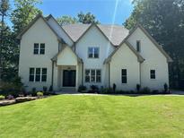 Two-story white brick home with gray accents, landscaping, and a large front yard at 270 Crosstree Ln, Atlanta, GA 30328