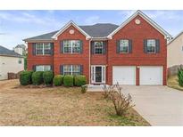 Two story brick home with two car garage and manicured lawn at 3756 Bondurant Dr, Douglasville, GA 30135