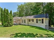 Brick house with a covered porch and manicured lawn at 1886 S Gordon Sw St, Atlanta, GA 30310