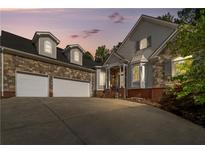 Elegant two-story home with stone accents and a three-car garage at 6159 Fernstone Nw Ct, Acworth, GA 30101