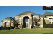 Two-story brick home with large windows and landscaping at 1819 Trinidad, Stockbridge, GA 30281