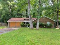 Ranch style home with wood siding and mature trees at 445 Independence Dr, Jonesboro, GA 30238