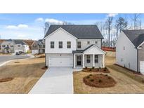 Two story house with gray brick and white accents at 1718 Lacebark Elm Way, Lawrenceville, GA 30045