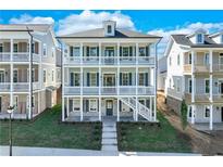 Two-story home with wraparound porch and brick facade at 1284 Six Sisters St, Dacula, GA 30019