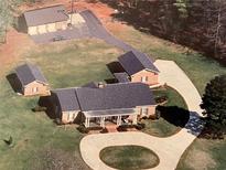 Aerial view of house, detached garages, and circular driveway at 3355 Smithtown Rd, Suwanee, GA 30024