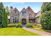 Stone and brick exterior of a charming two-story home with manicured landscaping at 56 Mount Paran Rd, Atlanta, GA 30327