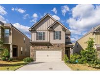 Two story home with a large garage and manicured lawn at 513 Dasheill Ln, Atlanta, GA 30349