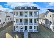 Beautiful three-story home with charming double-decker porches and a welcoming front entrance at 1264 Six Sisters St, Dacula, GA 30019