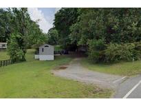 Gravel driveway entrance to property with trees at 160 Scott Rd, Canton, GA 30115