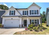 Two-story white house with black shutters, a two-car garage, and landscaped yard at 208 Eva Ne Way, Cartersville, GA 30121