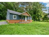 Charming one-story house with a green lawn at 7427 W Fayetteville Rd, Riverdale, GA 30296