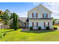 Two-story house with vinyl siding, stone accents, and a well-maintained lawn at 726 Fir Chase, Fairburn, GA 30213